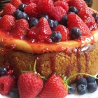 Vanilla Bean Cheesecake with fresh berries and honey drizzle